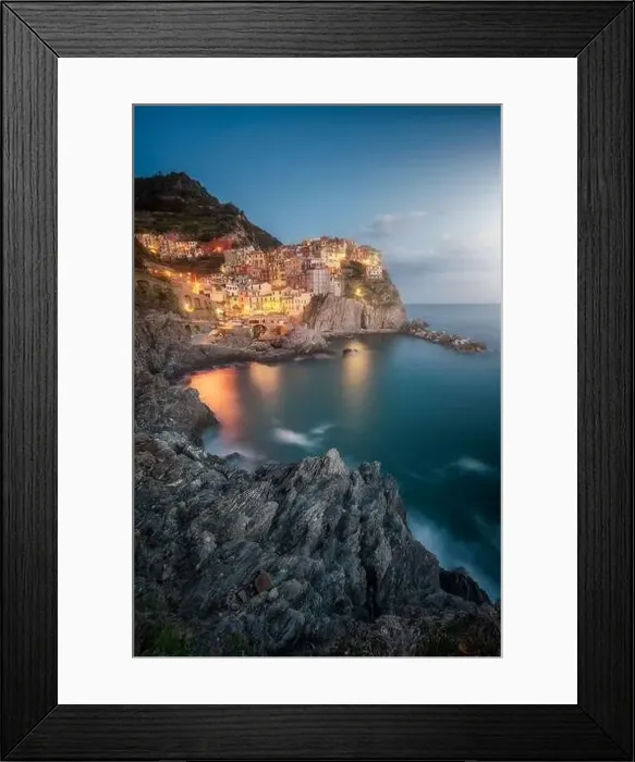 Framed Print : Amazing landscape with small town with colorful lights on rocky coast washing by tranquil ocean water at night Framed Print : Amazing landscape with small town with colorful lights on rocky coast washing by tranquil ocean water at night