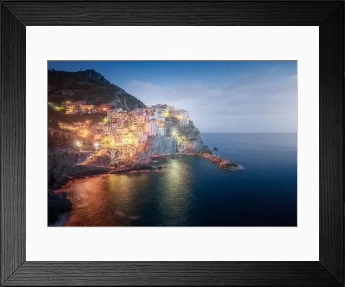 Framed Print : Amazing landscape with small town with colorful lights on rocky coast washing by tranquil ocean water at night Framed Print : Amazing landscape with small town with colorful lights on rocky coast washing by tranquil ocean water at night