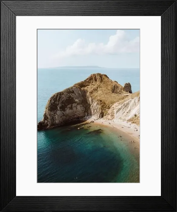 Framed Print : From above idyllic seascape with rocks called Durdle Door and people relaxing on seashore on summer day Framed Print : From above idyllic seascape with rocks called Durdle Door and people relaxing on seashore on summer day
