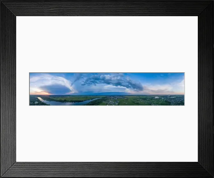Framed Print : Panoramic aerial view of the nature landscape with green meadows and a river at sunset Framed Print : Panoramic aerial view of the nature landscape with green meadows and a river at sunset