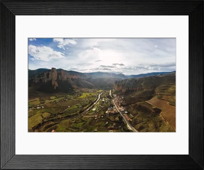 Framed Print : Drone view of scenic grassy mountain slopes and fields with infrastructure in valley Framed Print : Drone view of scenic grassy mountain slopes and fields with infrastructure in valley