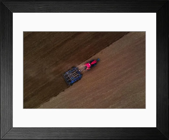 Framed Print : Farmer with tractor tilling the field to open the soil Framed Print : Farmer with tractor tilling the field to open the soil