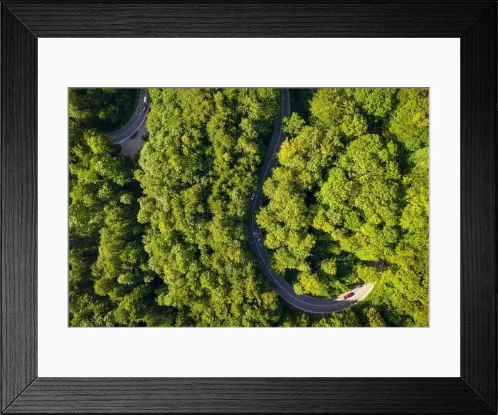 Framed Print : Aerial of driving cars through a green Framed Print : Aerial of driving cars through a green