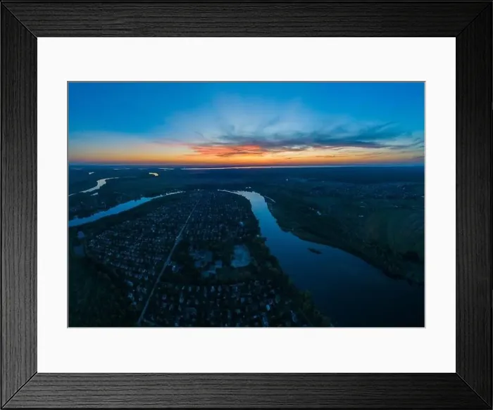 Framed Print : Panoramic aerial view of the nature landscape with green meadows and a river at sunset Framed Print : Panoramic aerial view of the nature landscape with green meadows and a river at sunset