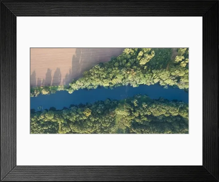 Framed Print : Top view of the river with turns of meanders and green forests in bright sunlight Framed Print : Top view of the river with turns of meanders and green forests in bright sunlight