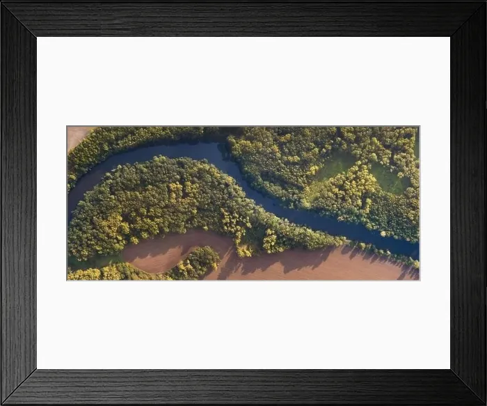 Framed Print : Top view of the river with turns of meanders and green forests in bright sunlight Framed Print : Top view of the river with turns of meanders and green forests in bright sunlight