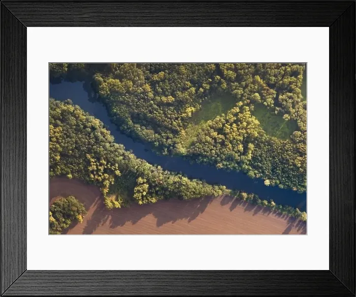 Framed Print : Top view of the river with turns of meanders and green forests in bright sunlight Framed Print : Top view of the river with turns of meanders and green forests in bright sunlight