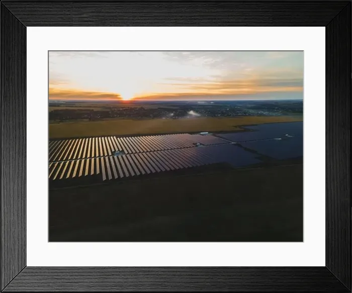 Framed Print : Aerial drone view into large solar panels at a solar farm in large field on countryside at bright sunset
