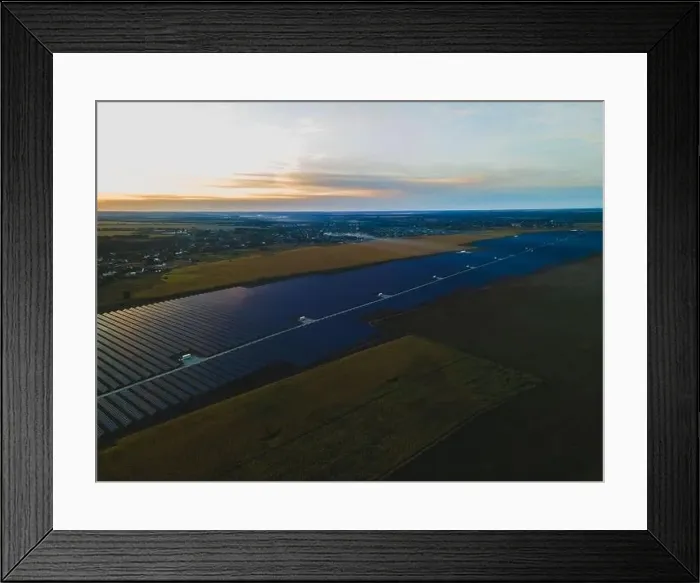 Framed Print : Aerial drone view into large solar panels at a solar farm in large field on countryside at bright sunset Framed Print : Aerial drone view into large solar panels at a solar farm in large field on countryside at bright sunset