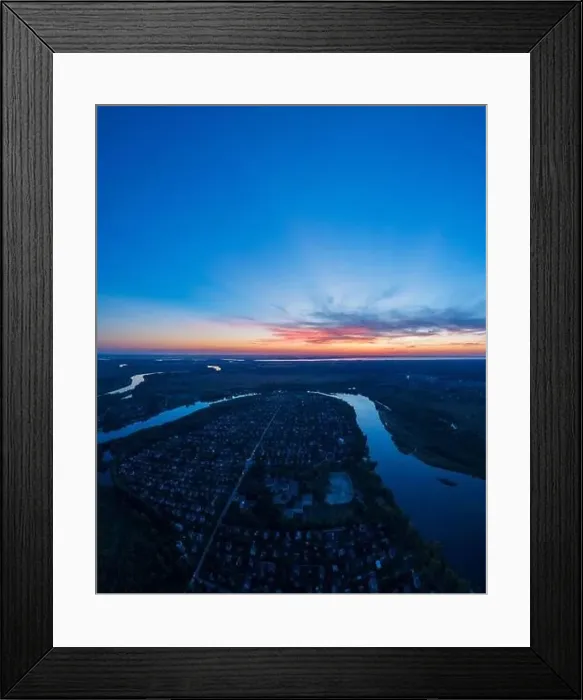 Framed Print : Panoramic aerial view of the nature landscape with green meadows and a river at sunset Framed Print : Panoramic aerial view of the nature landscape with green meadows and a river at sunset