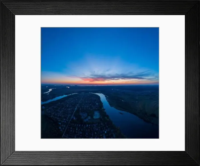 Framed Print : Panoramic aerial view of the nature landscape with green meadows and a river at sunset Framed Print : Panoramic aerial view of the nature landscape with green meadows and a river at sunset
