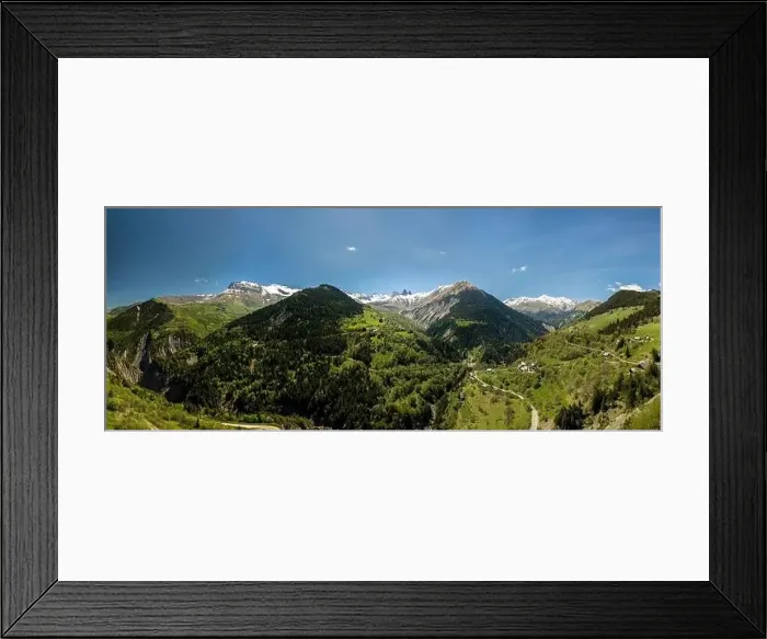 Framed Print : church in a village in the french alps with mountains 3000 meters high. Green meadows in spring. drone panning Framed Print : church in a village in the french alps with mountains 3000 meters high. Green meadows in spring. drone panning