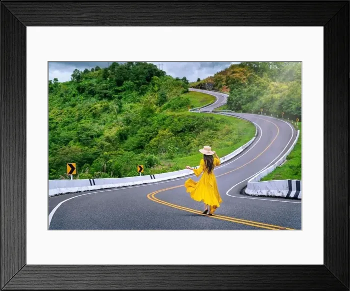 Framed Print : Woman walking on road no.3 or sky road over top of mountains with green jungle in Nan province, Thailand Framed Print : Woman walking on road no.3 or sky road over top of mountains with green jungle in Nan province, Thailand