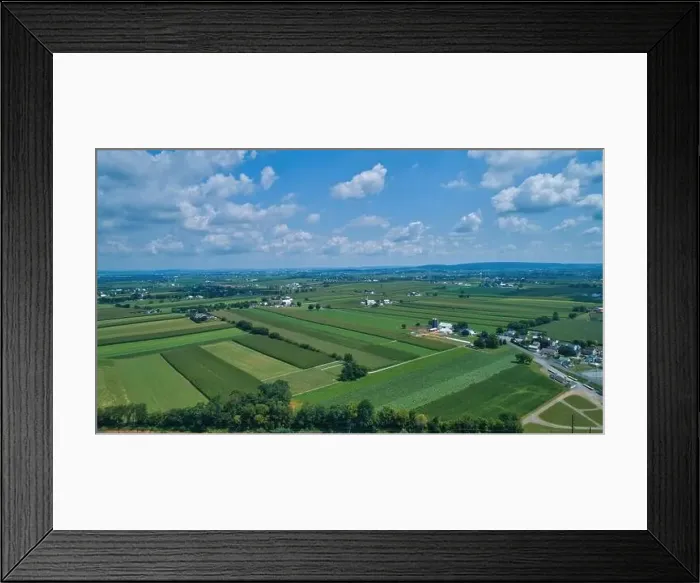 Framed Print : Aerial view of farm lands in summer with blue skies and white fluffy clouds Framed Print : Aerial view of farm lands in summer with blue skies and white fluffy clouds