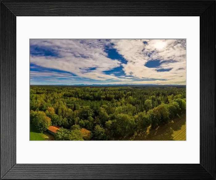 Framed Print : A beautiful view over a green forest at the early autumn with an idyllic house in the foreground, shot by a drone Framed Print : A beautiful view over a green forest at the early autumn with an idyllic house in the foreground, shot by a drone