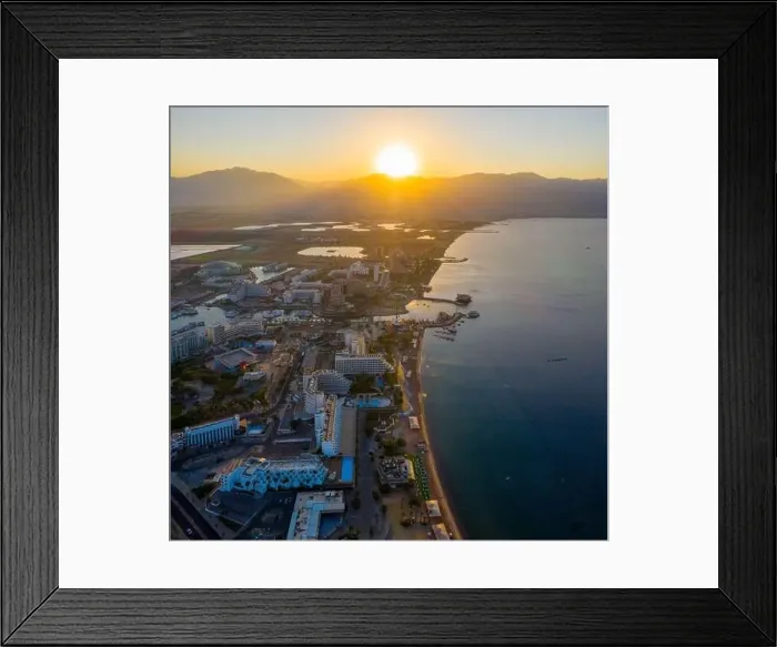 Framed Print : Sunrise over Eilat and The Red Sea, with waterfront hotels and Edom mountain ridge in the horizon, Aerial view Framed Print : Sunrise over Eilat and The Red Sea, with waterfront hotels and Edom mountain ridge in the horizon, Aerial view