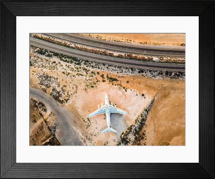 Framed Print : Abandoned airplane in the in the Umm Al Quwain desert in the emirate of the United Arab Emirates aerial view at sunrise Framed Print : Abandoned airplane in the in the Umm Al Quwain desert in the emirate of the United Arab Emirates aerial view at sunrise
