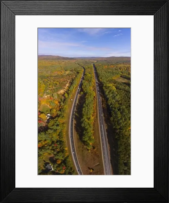 Framed Print : Interstate Highway 93 at Exit 22 with NH Route 127 in White Mountain National Forest aerial view with fall foliage