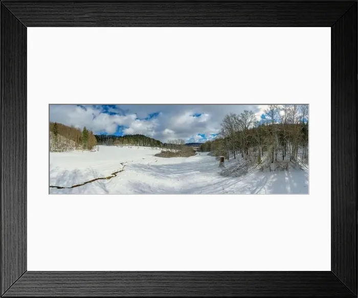 Framed Print : Idyllic snow covered landscape with a little creek in the foreground framed by trees Framed Print : Idyllic snow covered landscape with a little creek in the foreground framed by trees