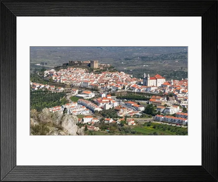Framed Print : Woman sitting on a rock viewing Castelo de Vide in Alentejo, Portugal from Serra de Sao Mamede mountains