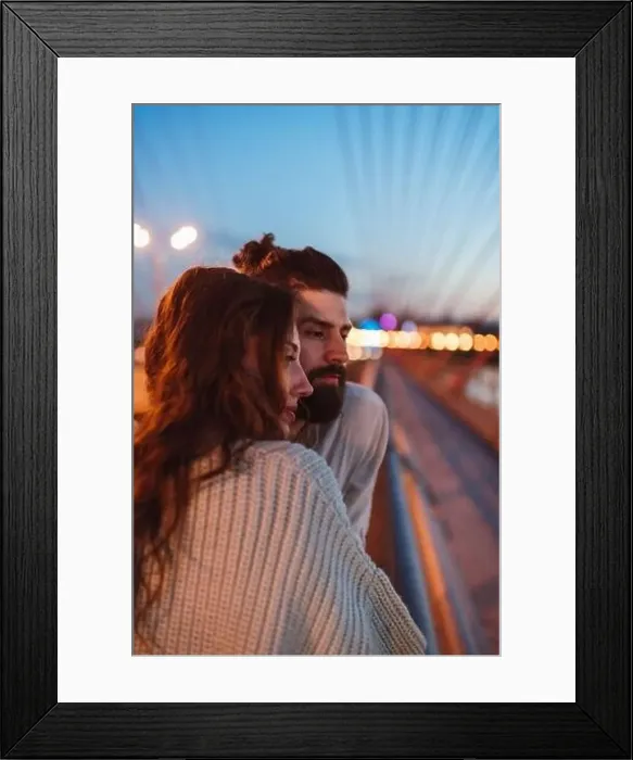 Framed Print : Thoughtful couple looking away while standing on bridge in city at dusk Framed Print : Thoughtful couple looking away while standing on bridge in city at dusk