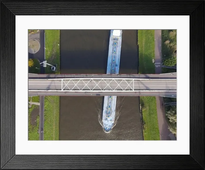 Framed Print : Aerial view of a bridge over a river with a water way river running underneath Framed Print : Aerial view of a bridge over a river with a water way river running underneath