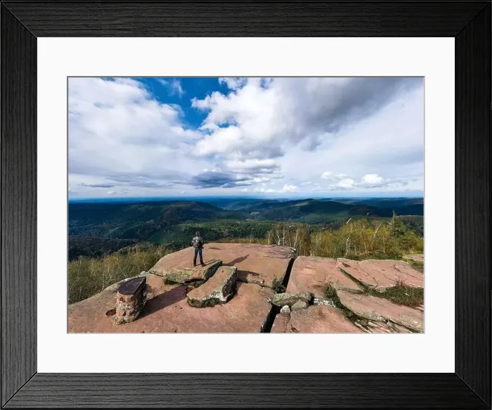 Framed Print : A man controls a drone standing on top of a cliff. Around the autumn mountain landscape. Vosges, Alsace. France Framed Print : A man controls a drone standing on top of a cliff. Around the autumn mountain landscape. Vosges, Alsace. France