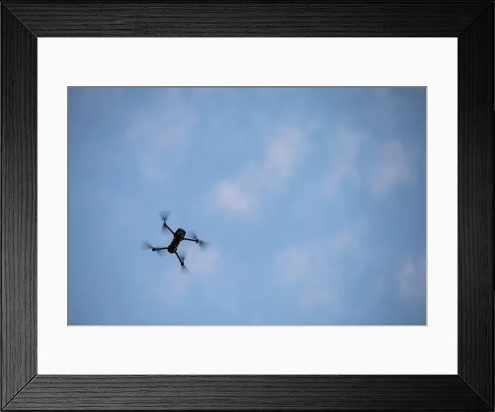 Framed Print : Color image of a drone flying at sunrise
