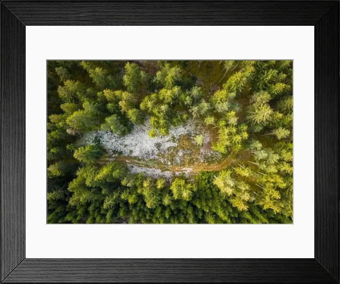 Framed Print : Aerial view of snowy forest with a little country road. Captured from above with a drone Framed Print : Aerial view of snowy forest with a little country road. Captured from above with a drone