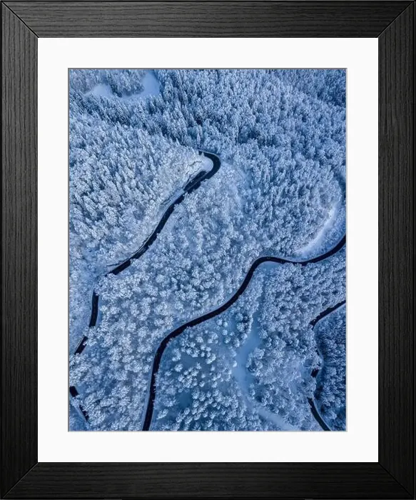 Framed Print : Stunning winter scene landscape of snow covered trees and forest as a road cuts through the landscape