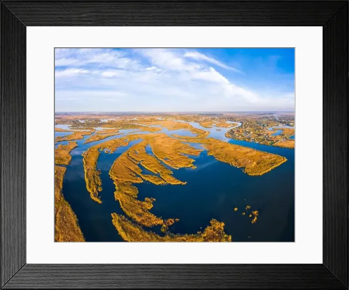 Framed Print : Top view of the beautiful Samarskie Plavni on the Dnieper with a village nearby in the warm evening light Framed Print : Top view of the beautiful Samarskie Plavni on the Dnieper with a village nearby in the warm evening light