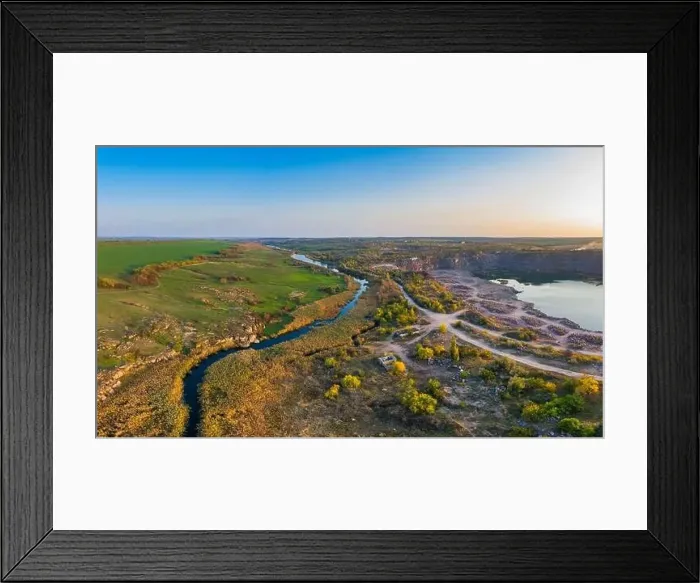 Framed Print : A small fast stream Kamenka in the wilderness in the evening light in Ukraine. Aerial panoramic drone shot Framed Print : A small fast stream Kamenka in the wilderness in the evening light in Ukraine. Aerial panoramic drone shot