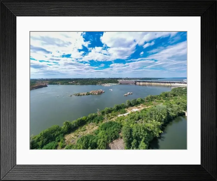 Framed Print : The beautiful river is surrounded by green and fresh vegetation in the city Framed Print : The beautiful river is surrounded by green and fresh vegetation in the city