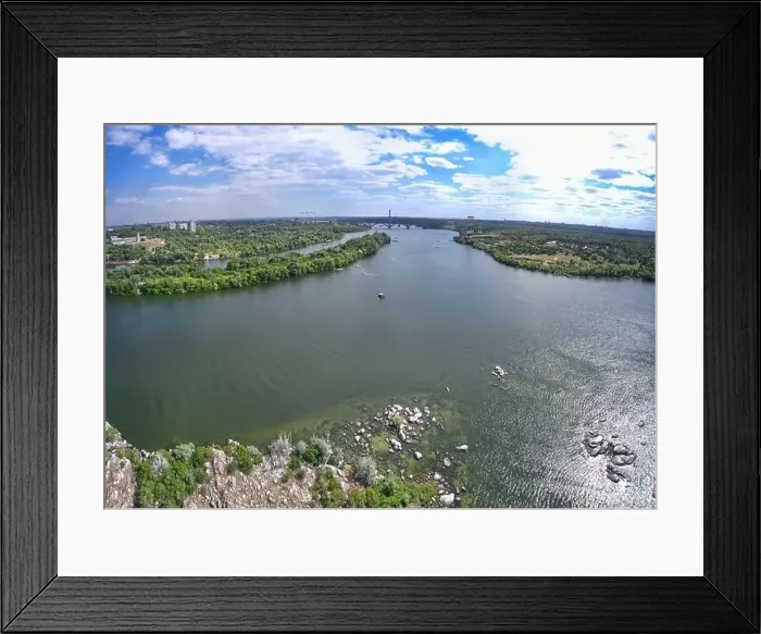 Framed Print : The beautiful river is surrounded by green and fresh vegetation in the city Framed Print : The beautiful river is surrounded by green and fresh vegetation in the city