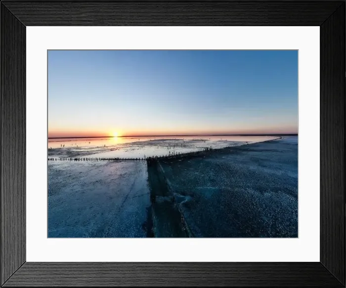 Framed Print : Top view of a shiny salty pink lake and a path along it Framed Print : Top view of a shiny salty pink lake and a path along it
