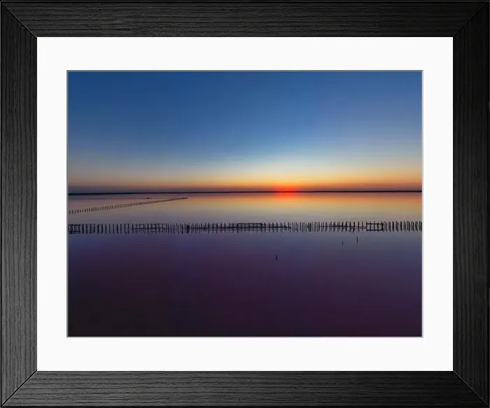 Framed Print : Top view of a shiny salty pink lake and a path along it Framed Print : Top view of a shiny salty pink lake and a path along it