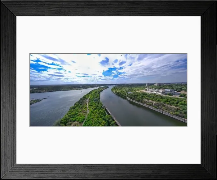 Framed Print : The beautiful river is surrounded by green and fresh vegetation in the city Framed Print : The beautiful river is surrounded by green and fresh vegetation in the city