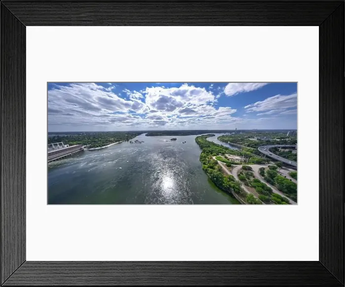 Framed Print : The beautiful river is surrounded by green and fresh vegetation in the city