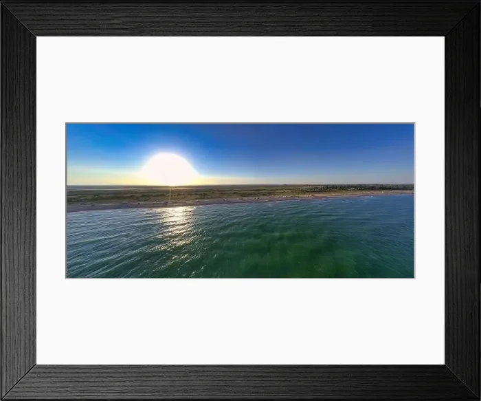 Framed Print : The edge of the sea in the evening sun. Camping beach. Drone shot 4K