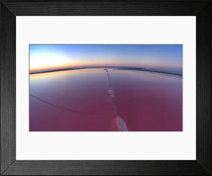 Framed Print : Top view of a shiny salty pink lake and a path along it Framed Print : Top view of a shiny salty pink lake and a path along it