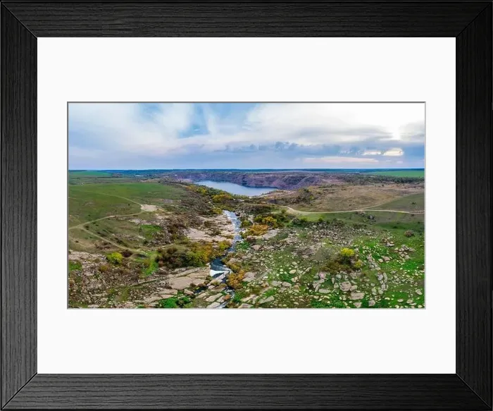 Framed Print : A small fast stream Kamenka in the wilderness in the evening light in Ukraine. Aerial panoramic drone shot Framed Print : A small fast stream Kamenka in the wilderness in the evening light in Ukraine. Aerial panoramic drone shot