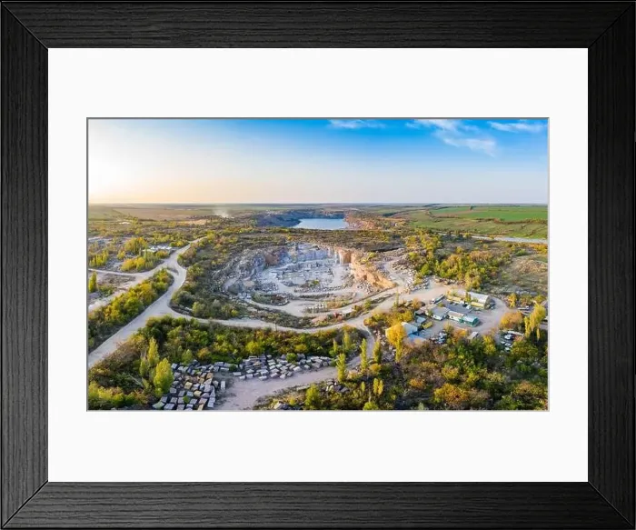 Framed Print : Extraction of minerals with the help of special equipment near a small lake in the warm evening light in picturesque Framed Print : Extraction of minerals with the help of special equipment near a small lake in the warm evening light in picturesque