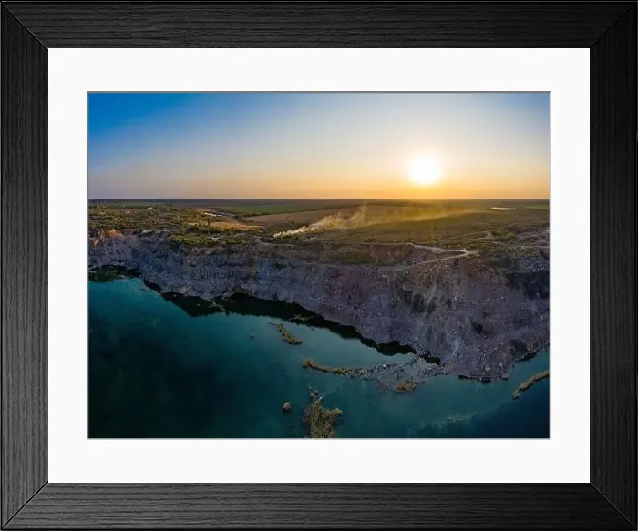Framed Print : Old flooded stone quarry with large stones in the evening warm bright light covered with small dry plants in Framed Print : Old flooded stone quarry with large stones in the evening warm bright light covered with small dry plants in