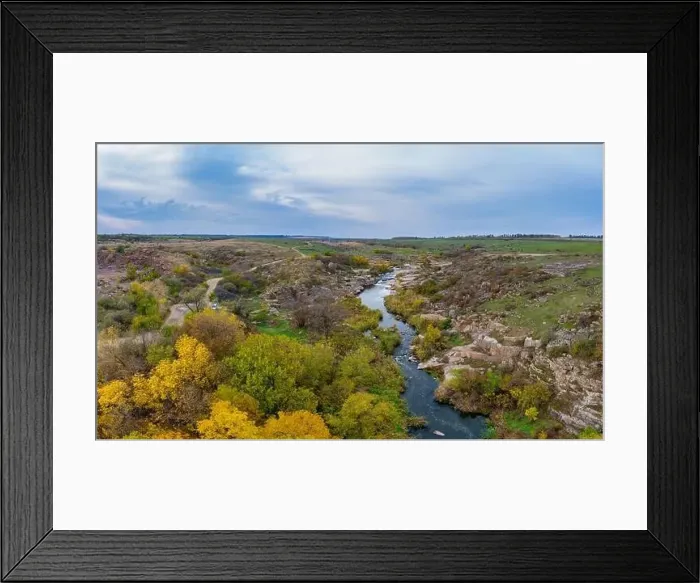 Framed Print : A small fast stream Kamenka in the wilderness in the evening light in Ukraine. Aerial panoramic drone shot Framed Print : A small fast stream Kamenka in the wilderness in the evening light in Ukraine. Aerial panoramic drone shot