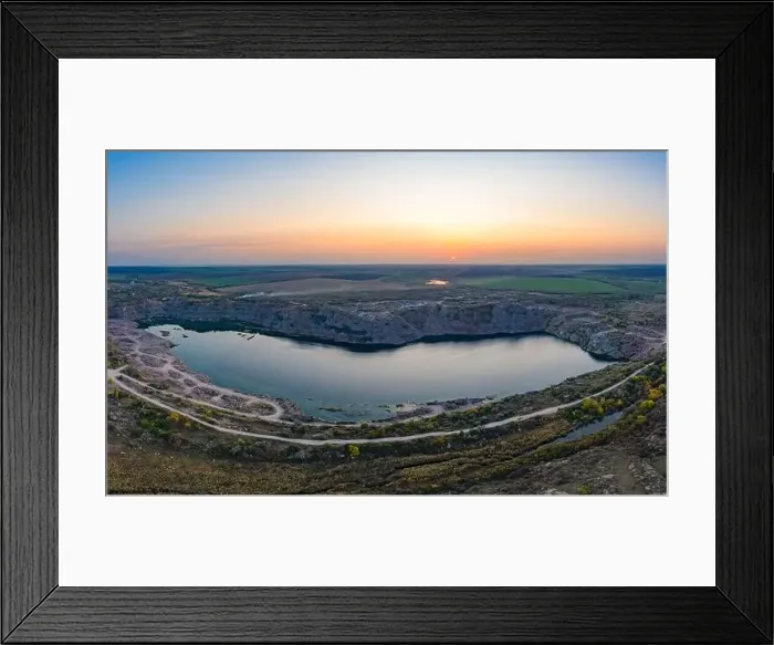 Framed Print : Old flooded stone quarry with large stones in the evening warm bright light covered with small dry plants in Framed Print : Old flooded stone quarry with large stones in the evening warm bright light covered with small dry plants in