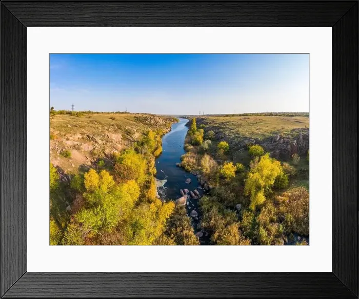 Framed Print : A small fast stream Kamenka in the wilderness in the evening light in Ukraine. Aerial panoramic drone shot Framed Print : A small fast stream Kamenka in the wilderness in the evening light in Ukraine. Aerial panoramic drone shot