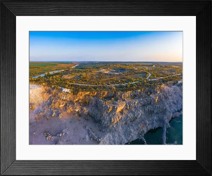 Framed Print : Old flooded stone quarry with large stones in the evening warm bright light covered with small dry plants in Framed Print : Old flooded stone quarry with large stones in the evening warm bright light covered with small dry plants in
