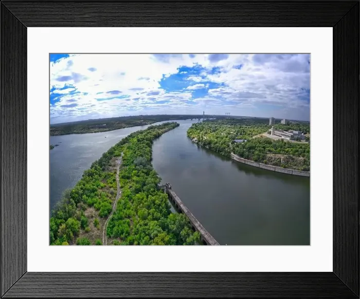 Framed Print : The beautiful river is surrounded by green and fresh vegetation in the city Framed Print : The beautiful river is surrounded by green and fresh vegetation in the city