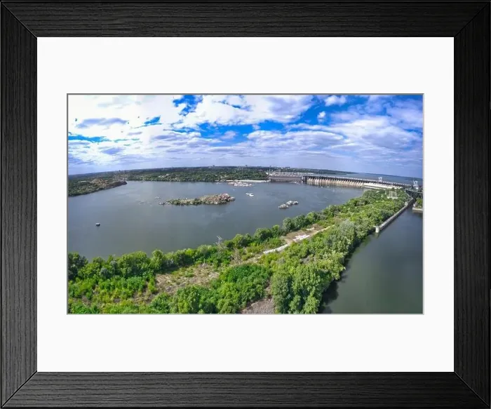 Framed Print : The beautiful river is surrounded by green and fresh vegetation in the city Framed Print : The beautiful river is surrounded by green and fresh vegetation in the city