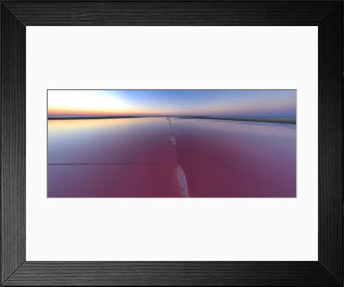 Framed Print : Top view of a shiny salty pink lake and a path along it Framed Print : Top view of a shiny salty pink lake and a path along it